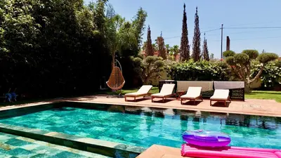 a swimming pool with lounge chairs and a swimming pool at villa white in Marrakech
