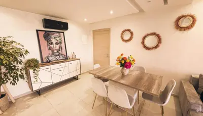 a dining room with a table and a couch at Apartment Coralia - Pool - Terrace in Marrakech