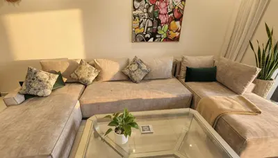 a living room with a couch and a glass table at Apartment Coralia - Pool - Terrace in Marrakech