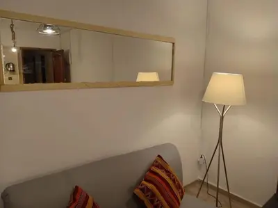 a mirror and a lamp in a room with a couch at appartement de luxe marrakech in Marrakech