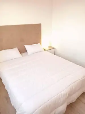 a large white bed in a white room at appartement de luxe marrakech in Marrakech