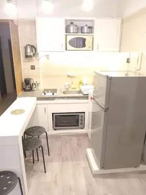 a small kitchen with a refrigerator and a sink at appartement de luxe marrakech in Marrakech