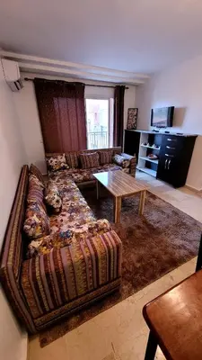 a living room with a couch and a table at Appartement 29 avec balcon pour famille in Marrakech