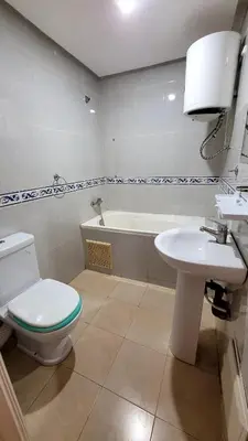 a bathroom with a toilet and a sink and a tub at Appartement 29 avec balcon pour famille in Marrakech