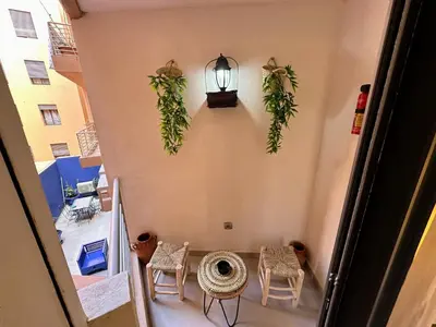 a hallway with a table and chairs and a light at Les marguerites avec piscine près du jardin majorelle in Marrakech