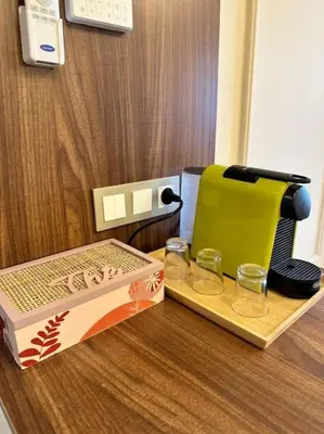 a coffee maker and two glasses on a table at Appartement Cosy à Marrakech in Marrakech