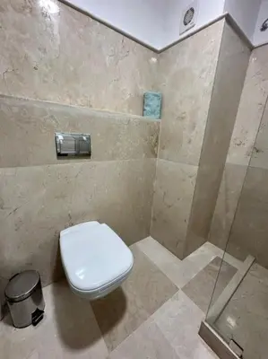 a bathroom with a toilet and a shower stall at Appartement Cosy à Marrakech in Marrakech