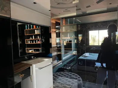 a person taking a picture of a kitchen with a sink at Appart 2 chambres luxe contemporain hivernage in Marrakech