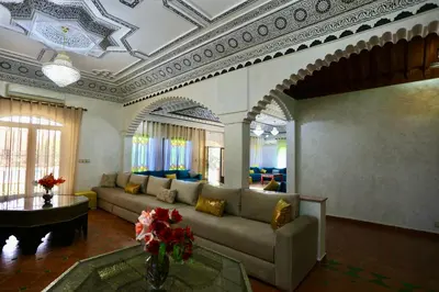 a living room with a couch and a table at Villa Les Terrasses Des Jardins in Marrakech