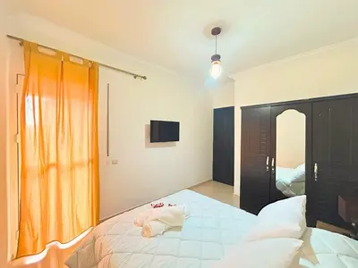 a bedroom with a large bed and a television at Le Paradise- Cosy, doux et Proche Centre in Marrakech