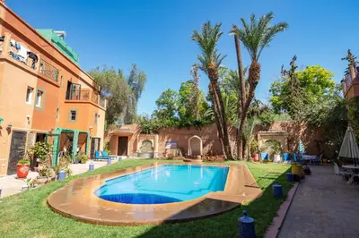 a swimming pool in the yard of a house at Riad Sofia in Marrakech