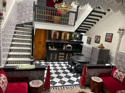 a living room with a staircase with a red couch at Riad Sofia in Marrakech