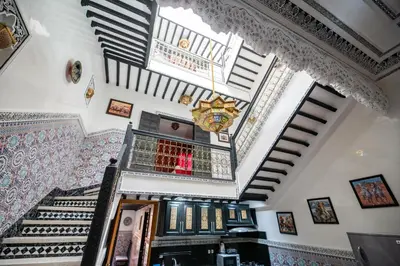 a staircase in a house with a chandelier at Riad Sofia in Marrakech