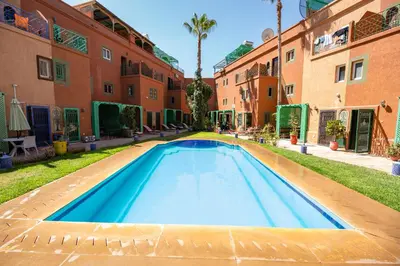 an empty swimming pool in a courtyard of a building at Riad Sofia in Marrakech