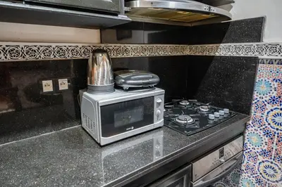 a microwave sitting on top of a kitchen counter at Riad Sofia in Marrakech