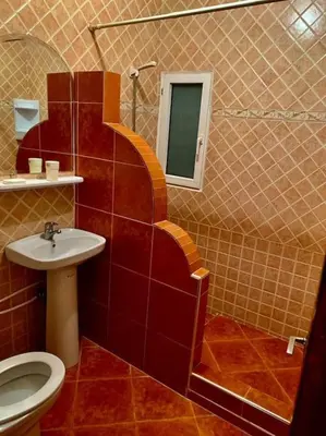 a bathroom with a sink and a toilet and a mirror at Riad Sofia in Marrakech