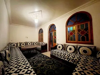 a living room with couches and a table at Maison d'hôtes Marrakech in Marrakech
