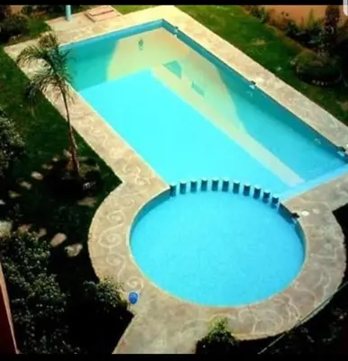 an overhead view of a large blue swimming pool at prestige andalouse 4 in Marrakech