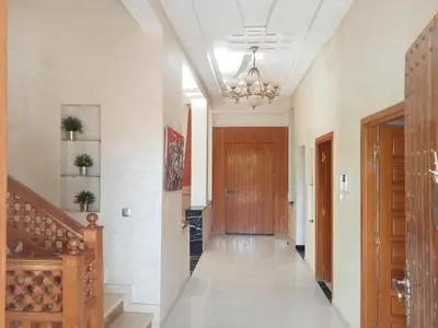 a hallway with a staircase and a wooden door at golf amelkis médina 1 N 50 in Marrakech