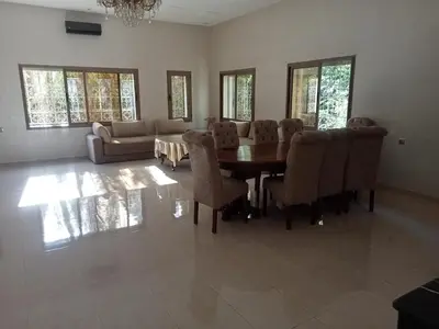 a living room with a table and chairs and a couch at golf amelkis médina 1 N 50 in Marrakech
