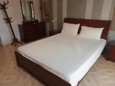 a bedroom with a large bed with white sheets and pillows at golf amelkis médina 1 N 50 in Marrakech