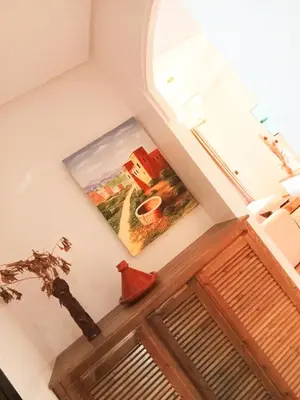 a room with a window and a picture on the wall at Somptueux appartement avec terrasse et piscines in Marrakech