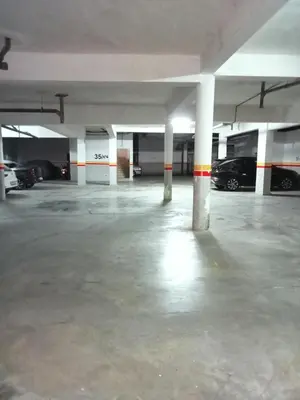 an empty parking garage with cars parked in it at Somptueux appartement avec terrasse et piscines in Marrakech