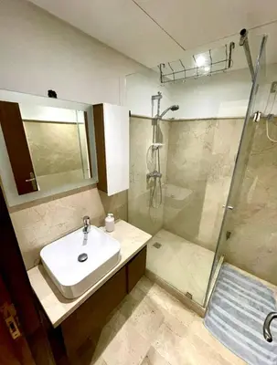 a bathroom with a sink and a shower at AMIZING Apartments Marrakech WAZO in Marrakech