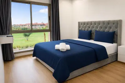 a bedroom with a bed with a towel on it at Expérience luxueuse Golf Prestigia Saphir BY KECH in Marrakech