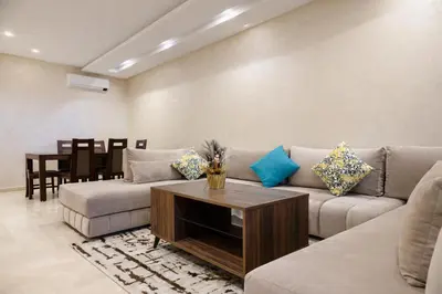 a living room with a couch and a table at Expérience luxueuse Golf Prestigia Saphir BY KECH in Marrakech