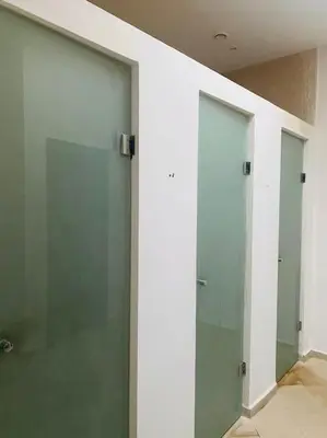 two glass doors in a room with a wall at Oasis aux Palmeraies à Marrakech in Marrakech