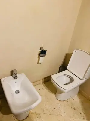 a bathroom with a white toilet and a sink at Oasis aux Palmeraies à Marrakech in Marrakech