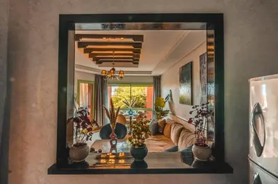 a mirror reflecting a living room with a couch at Marrakech Garden Tropical Escape in Marrakech