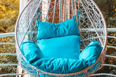 a chair with two blue pillows in it at Marrakech Garden Tropical Escape in Marrakech