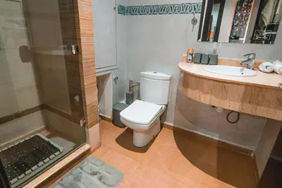 a bathroom with a shower and a toilet and a sink at Marrakech Garden Tropical Escape in Marrakech