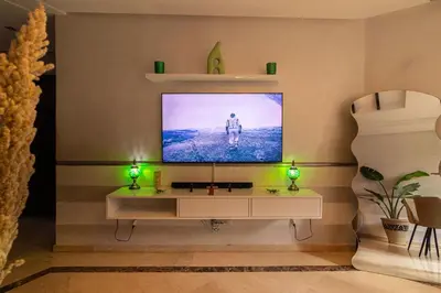 a living room with a television on a wall at Marrakech Garden Tropical Escape in Marrakech