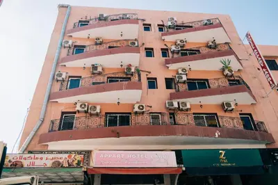 a tall building with balconies and air conditioners on it at Hotel Apart HLB in Marrakech