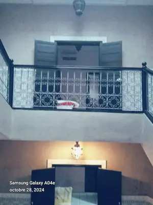 a staircase in a building with a balcony at Riad with swimming pool in Marrakech