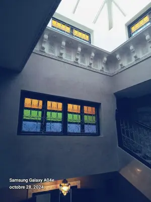 two windows in a room with lights on them at Riad with swimming pool in Marrakech