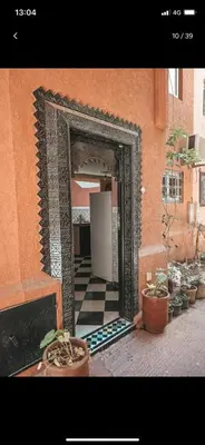 a mirror on the side of a building with potted plants at Riad with swimming pool in Marrakech