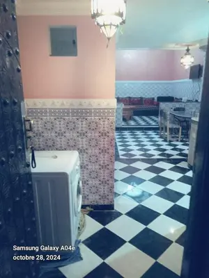 a bathroom with a checkered floor with a urinal at Riad with swimming pool in Marrakech