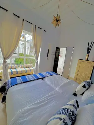 a bedroom with two large beds and a window at Riad privé luxe 3 chambres dans la médina de Marrakech y compris petit dejeuner in Marrakech