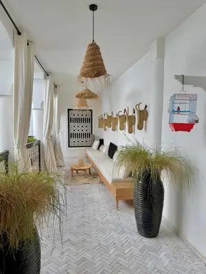 a living room with a couch and potted plants at Riad privé luxe 3 chambres dans la médina de Marrakech y compris petit dejeuner in Marrakech