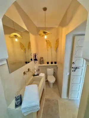 a bathroom with a tub and a toilet and a sink at Riad privé luxe 3 chambres dans la médina de Marrakech y compris petit dejeuner in Marrakech