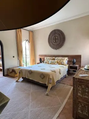 a bedroom with a large bed in a room at Dar Anacaona in Marrakech