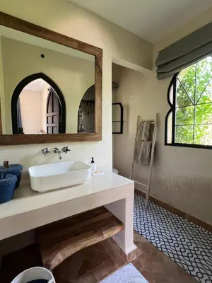 a bathroom with a sink and a mirror at Dar Anacaona in Marrakech