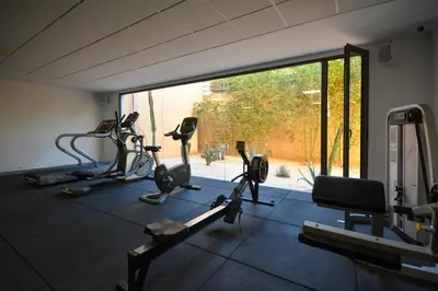 a gym with several exercise bikes and a large window at Duplexe Luxueux de 2 Suites in Marrakech