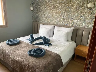 a bed with two blue towels on top of it at Prestigia 2 chambres vue piscine agate in Marrakech