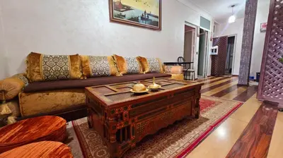 a living room with a couch and a coffee table at Cyndi Home Gueliz \u72ec\u4eab\u6574\u5957\u516c\u5bd3 in Marrakech