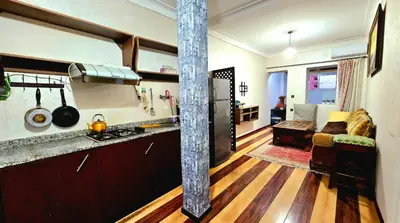 a kitchen and living room with a couch and a table at Cyndi Home Gueliz \u72ec\u4eab\u6574\u5957\u516c\u5bd3 in Marrakech
